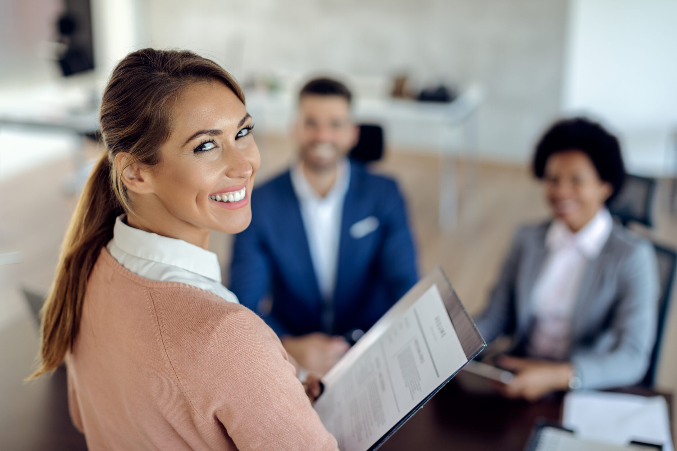 Young happy woman having an job interview in the office.